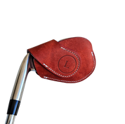Studio shot of leather magnetic golf iron covers in red neatly arranged to showcase their smooth texture, precise stitching, and minimalist design under soft lighting.